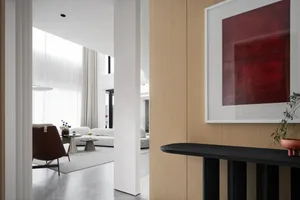A modern living room featuring sleek, contemporary decor, clean lines, and a brown accent chair.