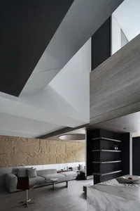 Minimalist modern living room featuring wood tiles and a concrete vault ceiling.