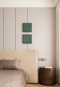 Modern minimalist bedroom featuring beige upholstered bed, green wall art, and wooden nightstand.