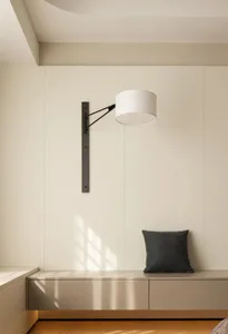 Modern minimalist bedroom with white furniture, wooden floor, and light fixture