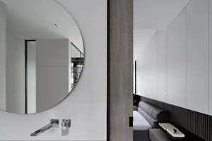 Modern minimalist bedroom with wood, concrete, and metal finishes.