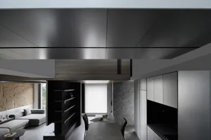 Modern interior design featuring an open-plan living room and kitchen with wood, marble, and concrete materials.