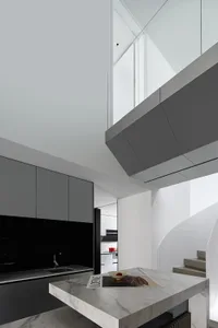 A modern residential interior showcasing marble countertops in a contemporary kitchen setting.