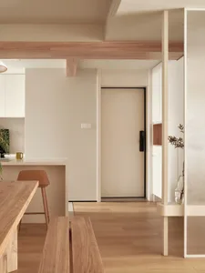 A minimalist residential interior with wood, glass, and concrete materials.
