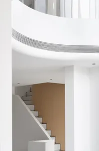 White minimalist interior with white tiles on walls and ceiling.