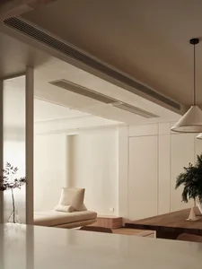 A minimalist living room featuring neutral-toned materials and clean lines.