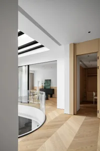 Modern minimalist living room interior with hardwood flooring, featuring sleek furniture, large windows, and a contemporary v
