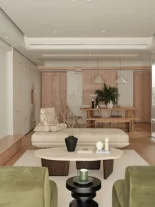 A modern living room with neutral-colored furniture and a minimalist design.