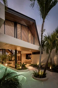 An elegant modern residential interior featuring a mix of wood and stone materials and a serene atmosphere.