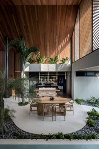 Modern residential interior featuring a combination of wood, concrete, and stone materials.