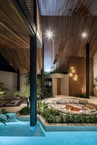 A modern residential spa with wooden interior, glass walls, and metal accents.
