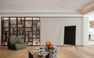 A modern living room featuring a wooden coffee table with a vase of flowers and a green beanbag chair.