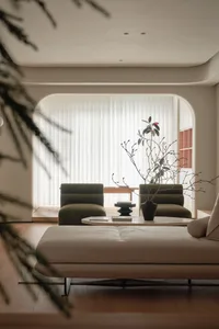 A modern minimalist living room with neutral colors and contemporary furniture.