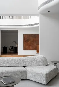 A modern minimalist living room with textured fabric furniture, clean lines, and a minimalist color palette.