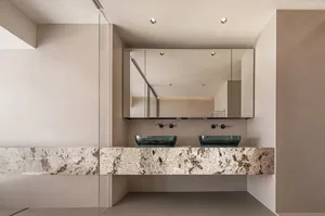 Modern bathroom with glass countertops and white walls.