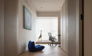 A modern home office featuring a glass window with a stylish interior design.