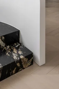Modern interior space with marble flooring and steps.