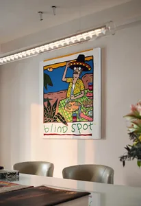 A modern interior design scene featuring a colorful painting of a man enjoying a picnic.