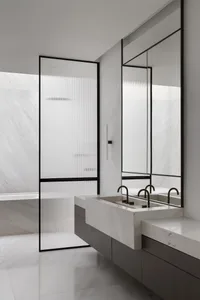 A modern bathroom with minimalist design featuring white marble