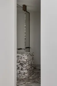 Modern bathroom with marble sink and floor.