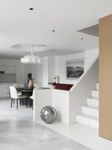 A minimalist residential interior with white marble and white lacquer finishes