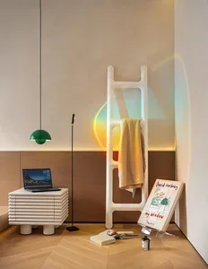 A modern interior living space with a neutral color palette featuring a wooden floor, wooden storage unit, green pendant ligh