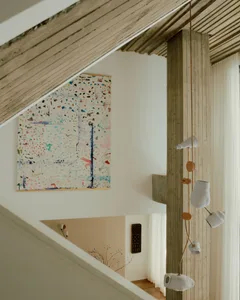 A contemporary residential stairway featuring white wood, concrete, and textiles.