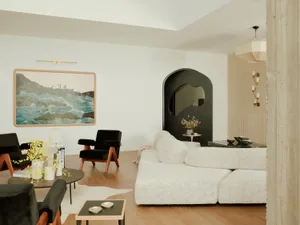 A modern living room featuring a white sofa, black armchairs, and a wooden floor with a cowhide rug. The decor includes a lar