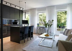 A contemporary kitchen with black cabinets, white curtains, and a marble countertop.