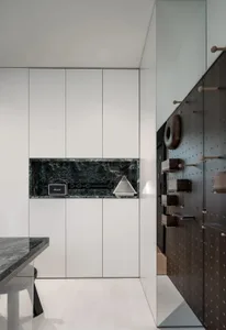 An industrial-style storage unit featuring metal finishes and a marble countertop.