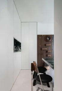 A modern interior design featuring metallic accents and minimalist furniture.