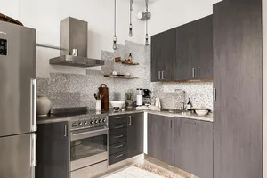 Modern kitchen featuring a stone backsplash with stainless steel appliances and dark cabinets.