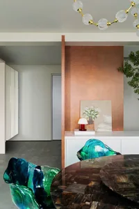 A modern living room featuring glass furniture and a wooden table.