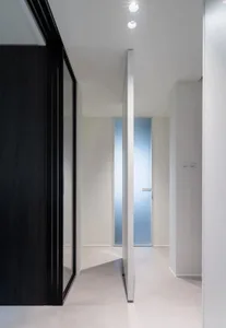 Modern minimalist interior design with glass walls and white walls and floors