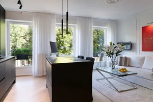 A modern minimalist living room featuring a comfortable couch adorned with decorative pillows, a sleek coffee table topped wi
