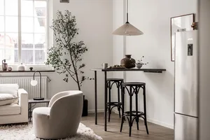 A modern residential kitchen featuring metal, wood, and ceramic elements.