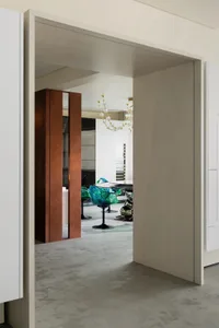 A modern vertical office space with a large glass wall and metal panels.