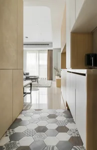 Modern kitchen and living room design with patchwork tiles floor and concrete countertop.