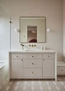 Modern bathroom interior featuring a white cabinet, minimalist design, and concrete detailing.