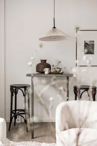 Minimalist Scandinavian living room with concrete table and wooden stools.