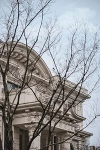 Close-up of a classical building facade with stone columns and decorative architectural elements.