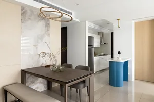 Modern dining and living room featuring a marble table and contemporary design elements