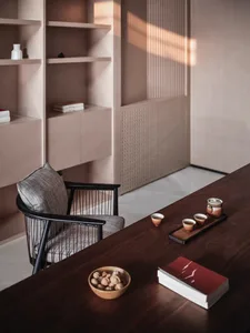 A modern office with a wooden desk, minimalist design, and a chair.
