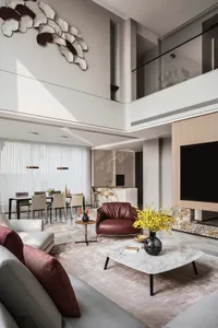 A modern living room featuring marble finishes and contemporary furniture.