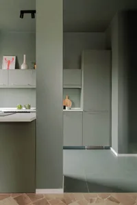 A modern kitchen featuring a terrazzo floor and minimalist design elements.