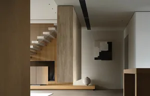 Modern minimalist living room with light-colored wooden walls and furniture, grey sofa, and grey floor.