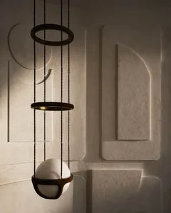 A modern interior space with textured concrete walls and a unique lighting fixture.