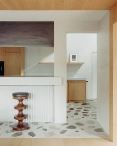 Modern kitchen with terrazzo flooring and minimalist design elements.