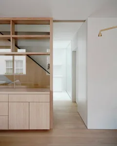 A modern interior design featuring wooden cabinets and glass walls.
