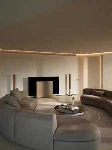Modern residential interior featuring taupe-colored plush sectionals and wooden fixtures.